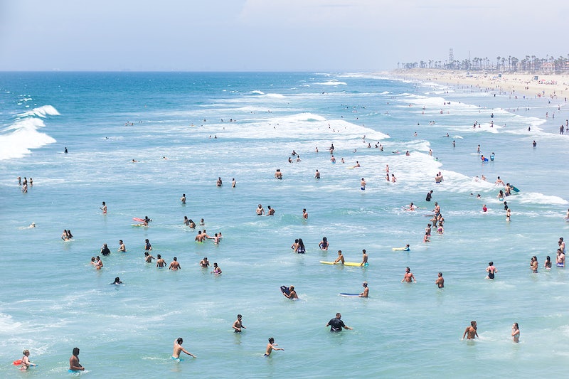 People swimming in the ocean, Praia Huntington, California.